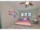 Charming bedroom featuring a ceiling fan, a cozy single bed, and a functional white desk at 11408 Drifting Leaf Dr, Riverview, FL 33579