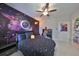Fun bedroom featuring a space mural wall and Pac-Personal themed bedspread at 11408 Drifting Leaf Dr, Riverview, FL 33579