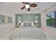 Calm bedroom with a plush bed, green accent wall, and natural light streaming through the window at 11408 Drifting Leaf Dr, Riverview, FL 33579