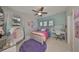 Charming bedroom with a colorful bed, window seats, and a cozy atmosphere at 11408 Drifting Leaf Dr, Riverview, FL 33579