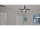 Bright bedroom with ceiling fan, double closet, and backyard view at 11408 Drifting Leaf Dr, Riverview, FL 33579
