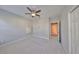 Spacious bedroom with neutral walls, carpet flooring, ceiling fan and an adjoining door at 11408 Drifting Leaf Dr, Riverview, FL 33579