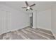 Open bedroom with neutral paint, wood-look floors, ceiling fan, and multiple doorways, ready to personalize at 11408 Drifting Leaf Dr, Riverview, FL 33579