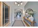 Bright entryway showcasing arched doorways, decorative console table, and stylish light fixture at 11408 Drifting Leaf Dr, Riverview, FL 33579
