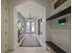 Inviting entryway with decorative console, mirror, arched doorways, and convenient bench seating at 11408 Drifting Leaf Dr, Riverview, FL 33579
