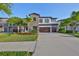 Inviting two-story home featuring stone facade, double garage, and a well-maintained front lawn at 11408 Drifting Leaf Dr, Riverview, FL 33579