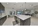 Bright, open kitchen featuring an island, stainless steel appliances, and views of the outdoor living area at 11408 Drifting Leaf Dr, Riverview, FL 33579