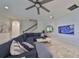 Cozy living room featuring a large sectional sofa, modern decor, and a ceiling fan at 11408 Drifting Leaf Dr, Riverview, FL 33579