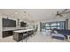 Open concept living room featuring a modern kitchen, dining area, and comfortable seating area at 11408 Drifting Leaf Dr, Riverview, FL 33579
