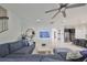 Comfortable living room featuring a ceiling fan, modern decor, and staircase access at 11408 Drifting Leaf Dr, Riverview, FL 33579