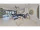 Bright living room with cozy blue sectional sofa, lake view, and stylish decor accents at 11408 Drifting Leaf Dr, Riverview, FL 33579