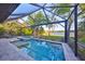 Screened lanai with pool, spa, and relaxing lake views, offering a perfect outdoor oasis at 11408 Drifting Leaf Dr, Riverview, FL 33579
