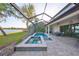 Inviting screened-in pool and spa area with stylish brick pavers and a serene lake view at 11408 Drifting Leaf Dr, Riverview, FL 33579