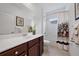 Clean bathroom featuring a shower, vanity with sink, and white tile flooring at 12225 Whisper Lake Dr, Bradenton, FL 34211