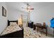 Bedroom with a ceiling fan, a single bed with floral pattern, and a writing desk at 12225 Whisper Lake Dr, Bradenton, FL 34211
