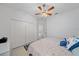 Bedroom with a ceiling fan, closet with white doors, and a patterned blue rug at 12225 Whisper Lake Dr, Bradenton, FL 34211