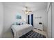 Cozy bedroom with a ceiling fan, a nautical themed bed, and a patterned blue rug at 12225 Whisper Lake Dr, Bradenton, FL 34211