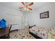 Bedroom featuring a ceiling fan, closet, desk, and a floral patterned rug at 12225 Whisper Lake Dr, Bradenton, FL 34211