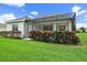 Back exterior view of home featuring a screened lanai and well-maintained lawn at 12225 Whisper Lake Dr, Bradenton, FL 34211