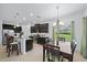 Bright kitchen features dark cabinetry, granite countertops, and a breakfast bar with seating near the adjacent dining area at 12225 Whisper Lake Dr, Bradenton, FL 34211