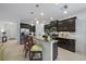 Modern kitchen boasts dark cabinets, granite countertops, stainless steel appliances and a breakfast bar at 12225 Whisper Lake Dr, Bradenton, FL 34211