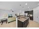 Open kitchen layout offers a kitchen island with granite countertops, seating and open views of the living room at 12225 Whisper Lake Dr, Bradenton, FL 34211