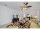 Cozy living room with a ceiling fan, television, a patterned rug, and ample natural light, creating a relaxing ambiance at 12225 Whisper Lake Dr, Bradenton, FL 34211