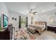 The main bedroom offers a ceiling fan, natural light, and a floral area rug providing a calming retreat at 12225 Whisper Lake Dr, Bradenton, FL 34211