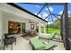 Spacious screened patio with ample seating, dining area, and views of the lush backyard at 12225 Whisper Lake Dr, Bradenton, FL 34211