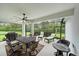 Relaxing screened patio featuring a ceiling fan, dining set, and comfortable lounge chairs at 12225 Whisper Lake Dr, Bradenton, FL 34211