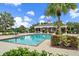 Community pool with a poolside lounging area, palm trees and pavilion at 12225 Whisper Lake Dr, Bradenton, FL 34211