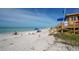 Scenic beach view featuring a lifeguard station and people enjoying the sun and sand on a clear day at 129 Taft Dr # W102, Sarasota, FL 34236