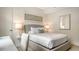 Well-lit bedroom with a neutral color palette, complemented by a desk and comfortable carpeting at 129 Taft Dr # W102, Sarasota, FL 34236
