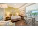Stylish bedroom with wood accents, a dedicated workspace, and a view of the living area at 129 Taft Dr # W102, Sarasota, FL 34236