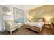 Stylishly decorated bedroom features a wooden bed frame and elegant wall art at 129 Taft Dr # W102, Sarasota, FL 34236