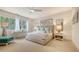 Bright and airy bedroom featuring a plush bed, stylish decor, and natural light from the window at 129 Taft Dr # W102, Sarasota, FL 34236