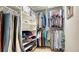 Spacious walk-in closet with built-in organizers, shelving, and hanging rods for efficient storage at 129 Taft Dr # W102, Sarasota, FL 34236