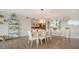 Open-concept dining area with stylish decor, wood-look floors, and lots of light at 129 Taft Dr # W102, Sarasota, FL 34236