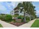 Modern residential building with lush landscaping, palm trees, and attractive signage at 129 Taft Dr # W102, Sarasota, FL 34236