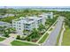 Modern apartment building with lush landscaping, balconies and manicured lawn at 129 Taft Dr # W102, Sarasota, FL 34236