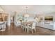 Bright and airy living and dining area with neutral tones and wood-look floors at 129 Taft Dr # W102, Sarasota, FL 34236