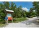 A nature park entrance featuring a map and information board with trees and a walking path at 129 Taft Dr # W102, Sarasota, FL 34236