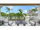 Beautiful outdoor patio with seating and clear views of palm trees, beach, and luxury condos at 129 Taft Dr # W102, Sarasota, FL 34236
