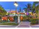 Night view of the Columbia Restaurant and surrounding businesses with tropical trees at 129 Taft Dr # W102, Sarasota, FL 34236