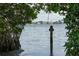 View of calm water with a group of people kayaking, framed by lush mangrove trees and greenery at 129 Taft Dr # W102, Sarasota, FL 34236