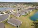 Aerial view of a beautiful community with serene lake views and well-maintained properties and green lawns at 13718 Woodbridge Ter, Lakewood Ranch, FL 34211