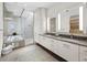 Modern bathroom featuring a soaking tub, walk-in shower, and dual sink vanity with contemporary fixtures at 1580 Harbor Cay Ln, Longboat Key, FL 34228