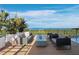 Rooftop deck with comfortable seating and panoramic ocean views at 1580 Harbor Cay Ln, Longboat Key, FL 34228