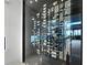 Close up image of a wine cellar filled with wine bottles and glass doors, showcasing the extensive collection within at 1580 Harbor Cay Ln, Longboat Key, FL 34228