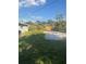 Large backyard featuring a new fence, mature trees, and lush greenery at 2020 45Th Street Ct E # A, Bradenton, FL 34208